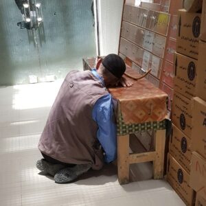 男性彎腰搬動紙箱，搬重物時的腰部負擔